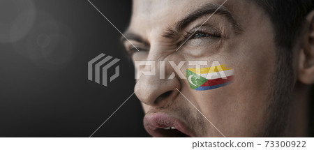 A screaming man with the image of the Comoros national flag on his face A screaming man with the image of the Comoros national flag on his face 73300922