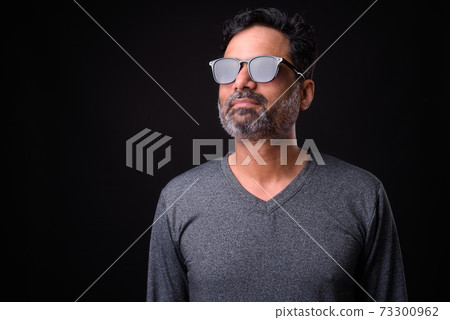Portrait of mature bearded Indian man with curly hair Portrait of mature bearded Indian man with curly hair 73300962