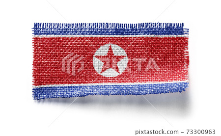 North Korea flag on a piece of cloth on a white background North Korea flag on a piece of cloth on a white background 73300963