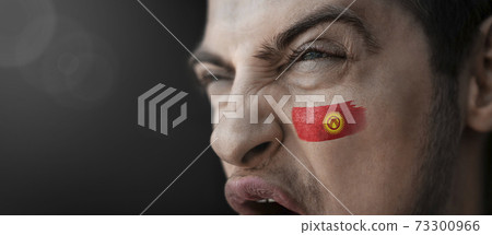 A screaming man with the image of the Kirghizia national flag on his face A screaming man with the image of the Kirghizia national flag on his face 73300966