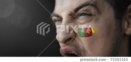 A screaming man with the image of the Cameroon national flag on his face A screaming man with the image of the Cameroon national flag on his face 73301163