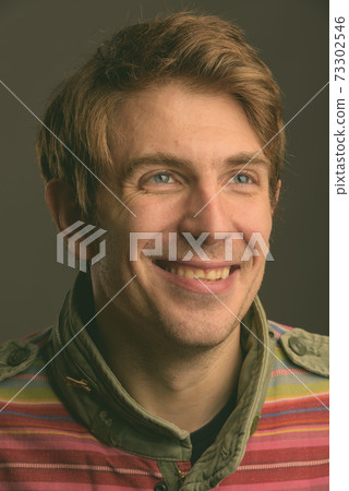 Handsome man against gray background 73302546