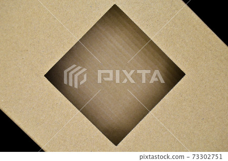 Cardboard box with open lid of corrugated cardboard isolated on black background Cardboard box with open lid of corrugated cardboard isolated on black background 73302751