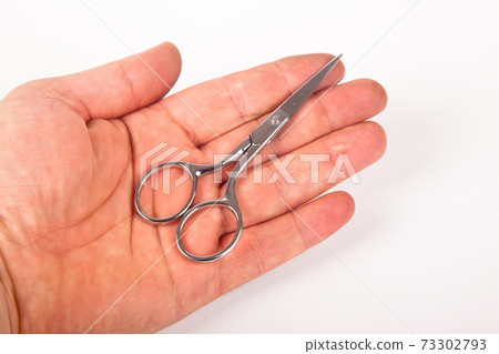 Retro professional small tailor scissors and hand, isolated on white background 73302793