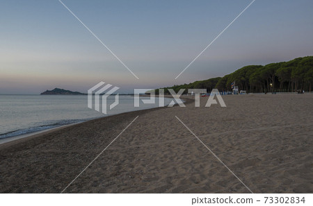 Early Morning Sunrise view of sand beach Spiaggia di Santa Maria Navarrese, sea with green forest and view of Arbatax penisula. Sardinia, Italy Early Morning Sunrise view of sand beach Spiaggia di Santa Maria Navarrese, sea with green forest and view of Arbatax penisula. Sardinia, Italy 73302834