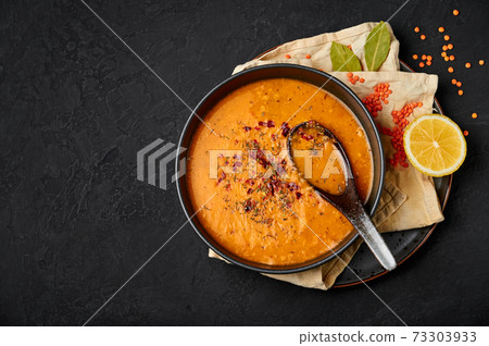 Ezogelin Soup in black bowl on dark slate table top. Turkish cuisine traditional dish  73303933