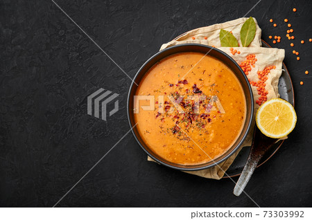 Ezogelin Soup in black bowl on dark slate table top. Turkish cuisine traditional dish  73303992