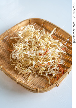 Handmade raw dried daikon radish in a basket 73305758