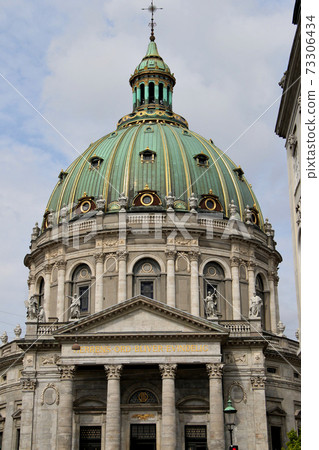 Vertical position with the dome of Frederik's Church, a landmark in Copenhagen, the capital of Denmark, up. Vertical position with the dome of Frederik's Church, a landmark in Copenhagen, the capital of Denmark, up. 73306434
