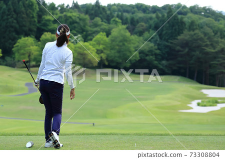 Image of a woman who finished hitting a tee shot Image of a woman who finished hitting a tee shot 73308804