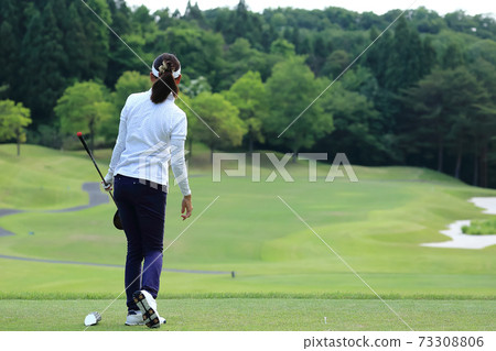 Image of a woman who finished hitting a tee shot Image of a woman who finished hitting a tee shot 73308806
