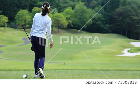 Image of a woman who finished hitting a tee shot Image of a woman who finished hitting a tee shot 73308819