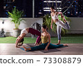 Asian weman group do yoga in city at night 73308879
