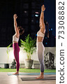 Asian women do yoga in city at night 73308882