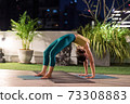 Asian woman do yoga in city at night 73308883