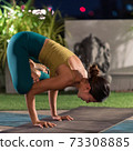 Asian woman do yoga in city at night 73308885
