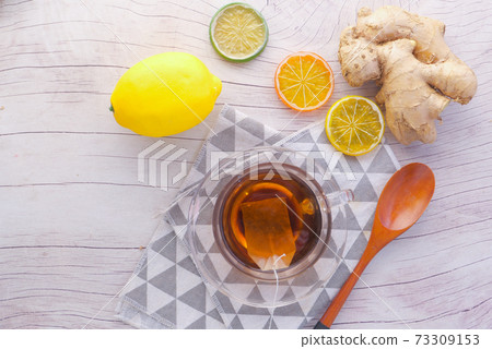 Top view of ginger tea on wooden background. 73309153