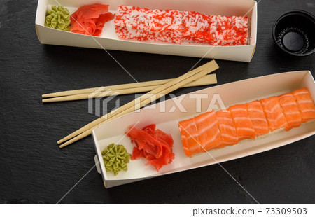 california sushi with red tobiko caviar and slices of philadelphia sushi with eel in a white box 73309503