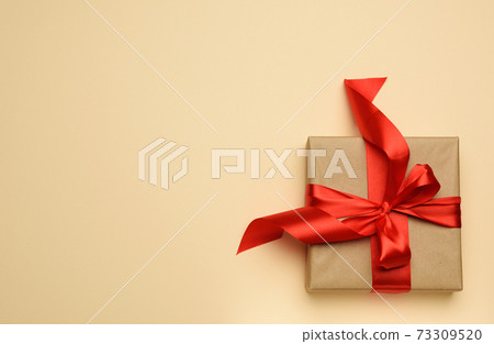 square gift box is packed in red paper and curled silk ribbon square gift box is packed in red paper and curled silk ribbon 73309520