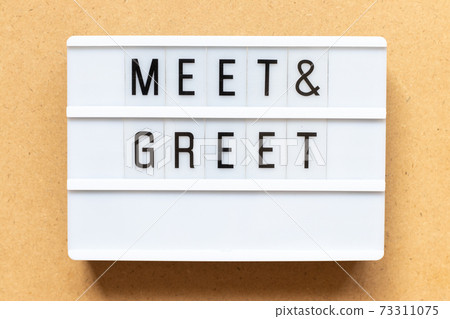 Lightbox with word meet and greet on wood background Lightbox with word meet and greet on wood background 73311075