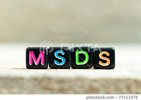 Black color block with word MSDS (Abbreviation of material safety data sheet)on wood background 73311078