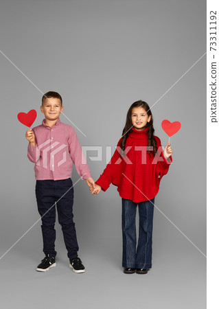 Happy couple little girl and boy with red hearts Happy couple little girl and boy with red hearts 73311192