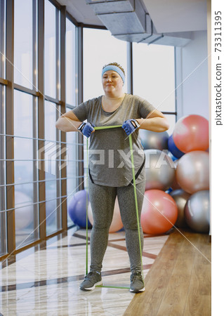 Adult fat woman doing gymnastics at the gym 73311395