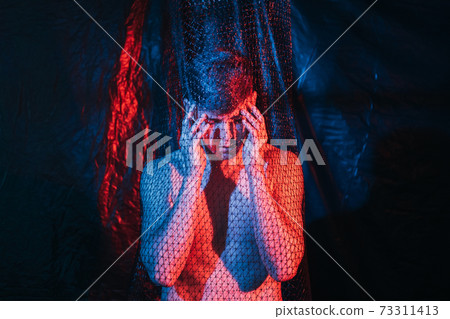 troubled man panic attack headache neon light dark 73311413