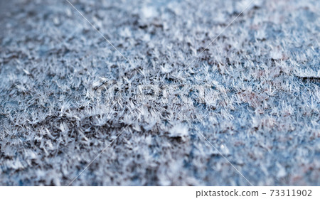 White hoarfrost crystals on flat surface closeup view White hoarfrost crystals on flat surface closeup view 73311902