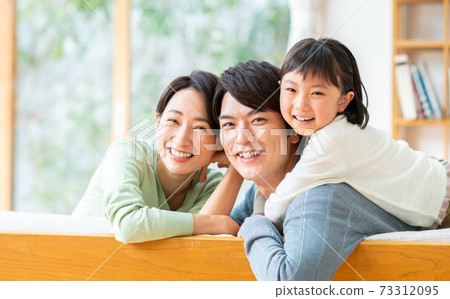 Young family in the living room 73312095