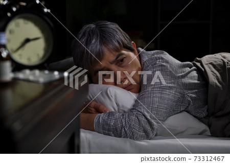 Depressed senior woman lying in bed cannot sleep from insomnia Depressed senior woman lying in bed cannot sleep from insomnia 73312467