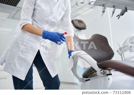 Dentist sterilize the medical equipment inside a dental clinic 73312806