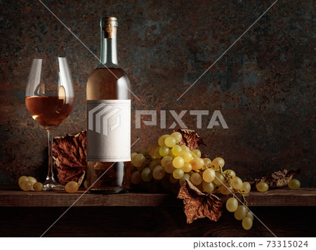Wine with grapes and dried up vine leaves. Wine with grapes and dried up vine leaves. 73315024