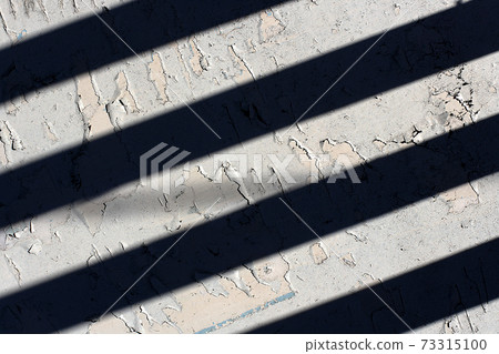 White painted surface with black stripes from the shade. White painted surface with black stripes from the shade. 73315100