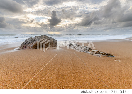 Rocks on a sandy beach in the Atlantic Ocean Rocks on a sandy beach in the Atlantic Ocean 73315381
