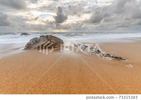 Rocks on a sandy beach in the Atlantic Ocean Rocks on a sandy beach in the Atlantic Ocean 73315383