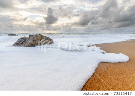 Rocks on a sandy beach in the Atlantic Ocean Rocks on a sandy beach in the Atlantic Ocean 73315417