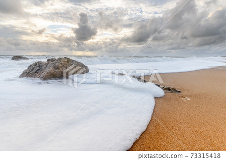 Rocks on a sandy beach in the Atlantic Ocean Rocks on a sandy beach in the Atlantic Ocean 73315418