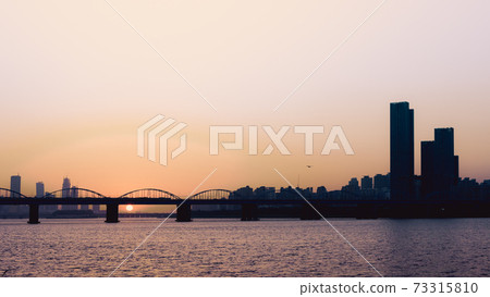 sunset with silhouette city and bridge background at seoul korea 73315810