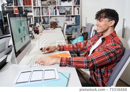 Designer sitting in front of the imac computer Designer sitting in front of the imac computer 73316888