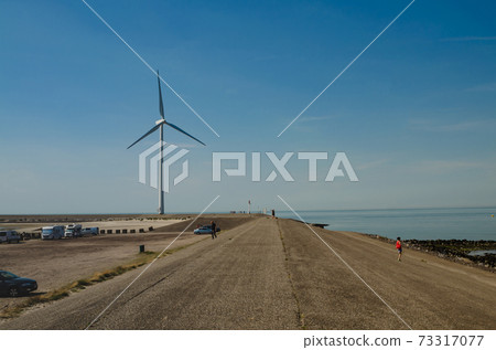 Oosterscheldekering, the netherlands, August 2019. In the Zeeland countryside, wind farms 73317077