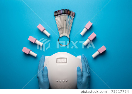 Set of manicure tools and accessories on a blue background. Hardware manicure,Flat lay. 73317734