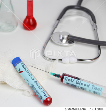 medical laboratory test tube with the word coronavirus test and syringe with blood inside, stethoscope, flasks, danger concept of the spread of the CoV virus medical laboratory test tube with the word coronavirus test and syringe with blood inside, stethoscope, flasks, danger concept of the spread of the CoV virus 73317801