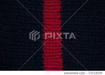 Handmade knitted fabric red and navy wool background texture 73318505