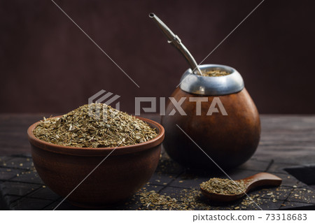 Calabas with bombilla and mate in a bowl 73318683