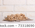 Pricked brown cane sugar on linen cloth 73318690