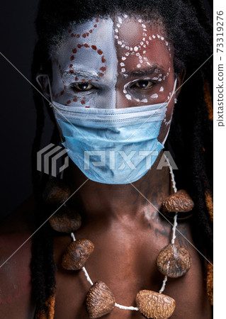 close-up portrait of serious male in medical mask looking at camera close-up portrait of serious male in medical mask looking at camera 73319276