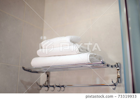 A stack of white towels in the hotel bathroom.set of towels for washing 73319933