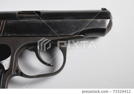 Old Soviet pistol. Close-up on white background 73320412