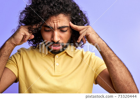 young curly man is trying to remember young curly man is trying to remember 73320444